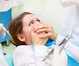 Closeup portrait young terrified girl woman scared at dentist visit, s